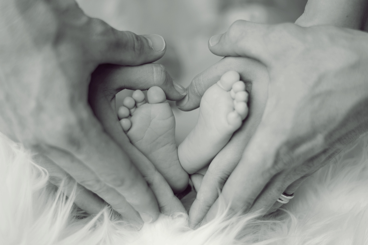 Parents Hands Holding Baby Feet